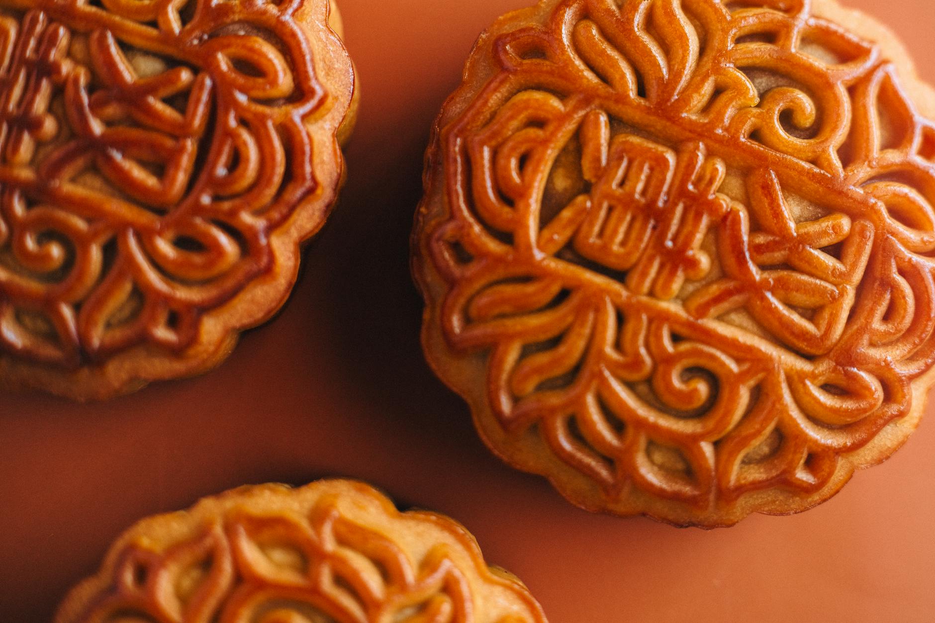 Close-up of ornate mooncakes showcasing traditional Chinese pastry art, perfect for festive celebrations.