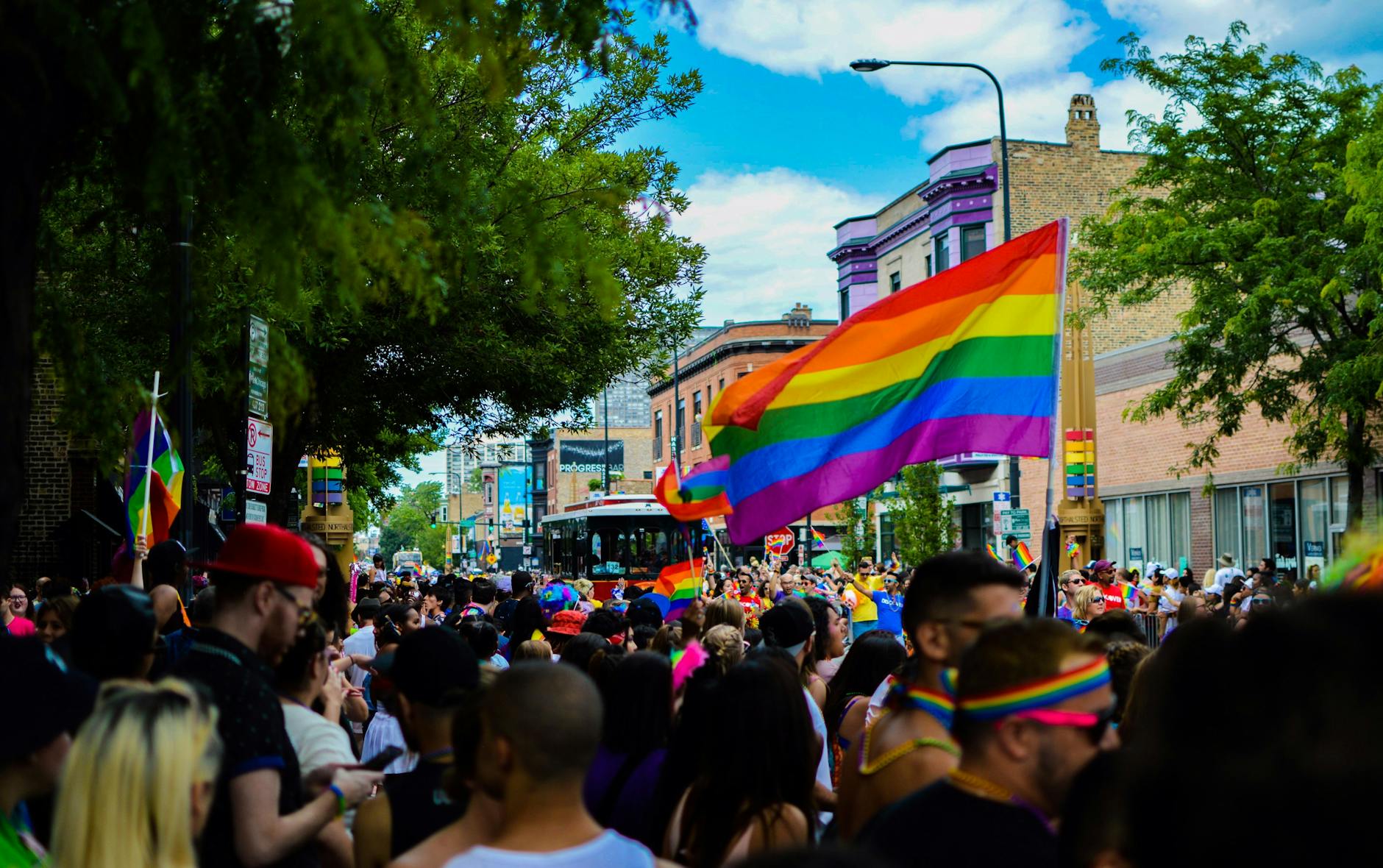 Lively Pride Parade with colorful flags and diverse crowd in Chicago.