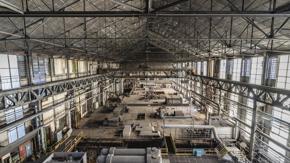 Spacious industrial warehouse interior with steel structures and heavy machinery