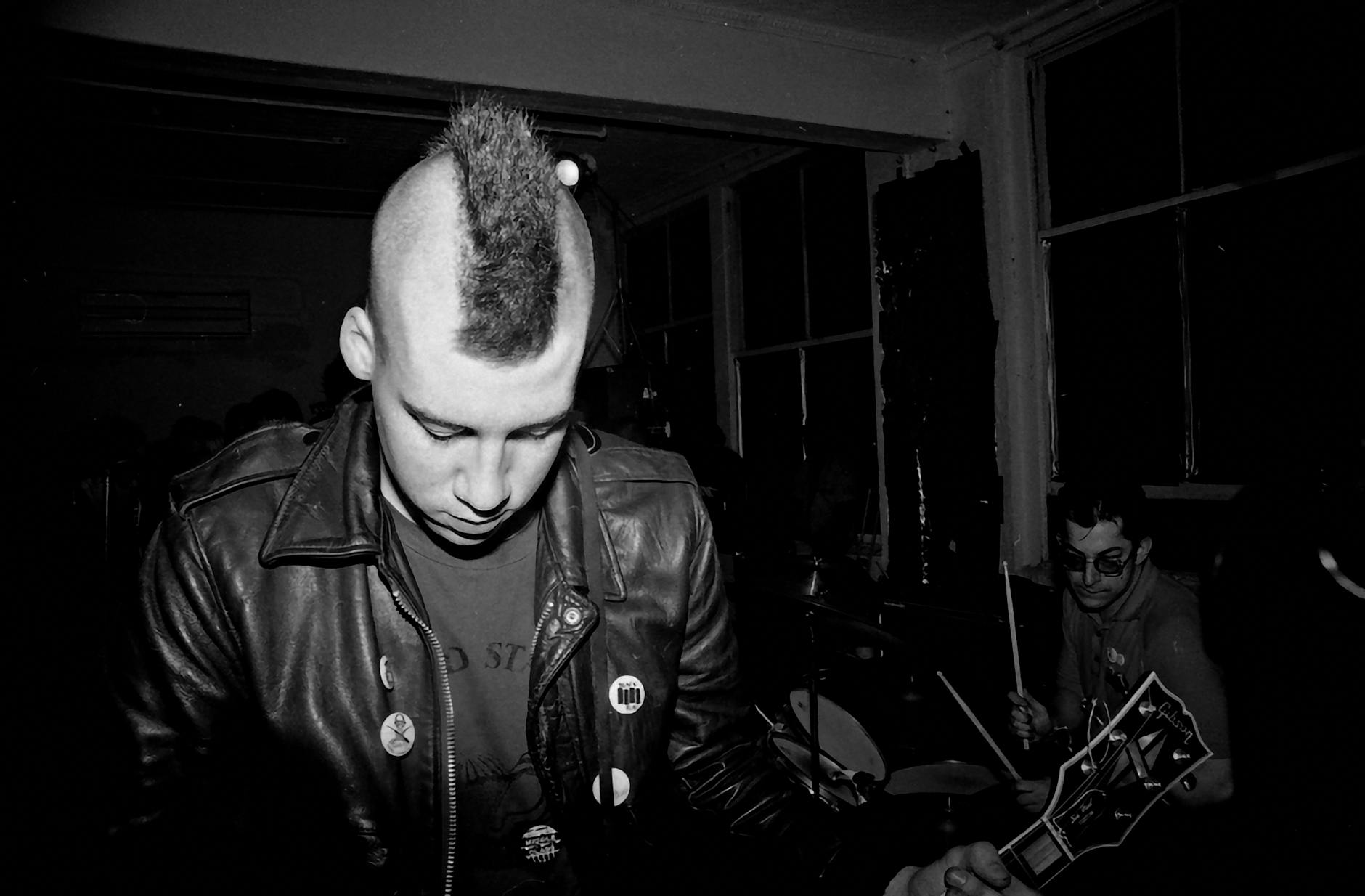 Moody monochrome image of a punk band capturing the energy of live music.
